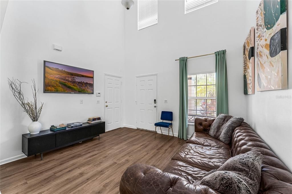 View from kitchen to the living room, door to the garage and townhome entrance.