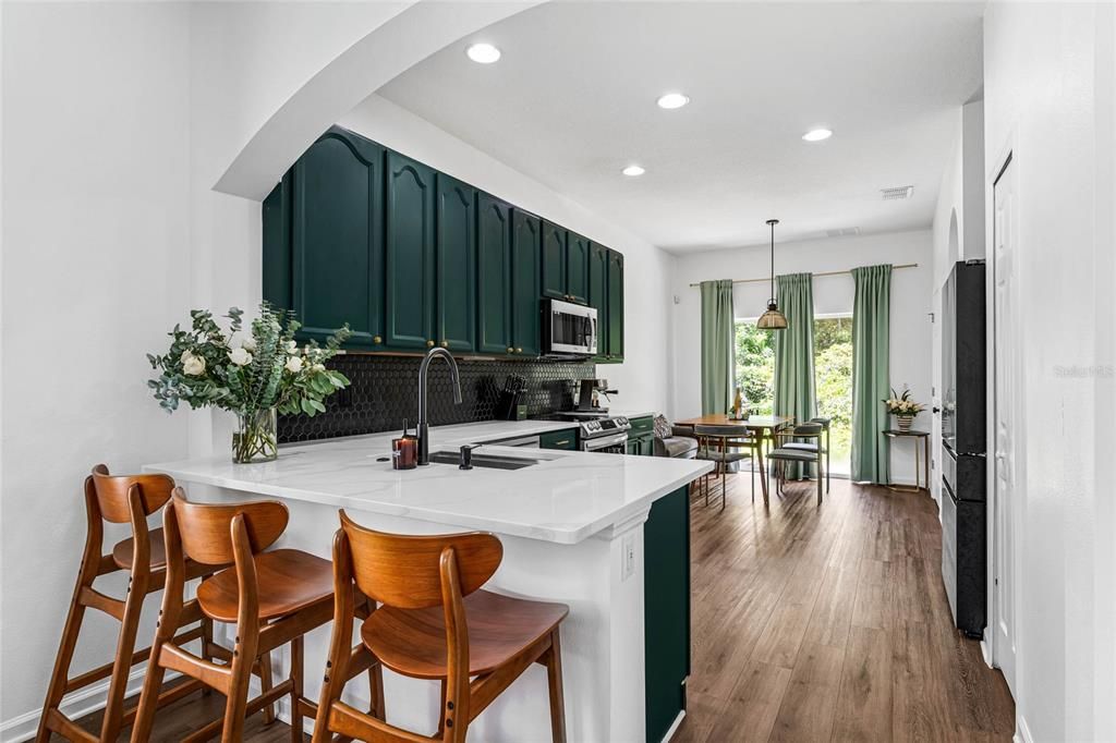 Kitchen area with multiple eating spaces.