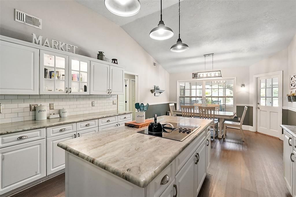 Kitchen looks onto the dinette which leads to the lanai/pool area