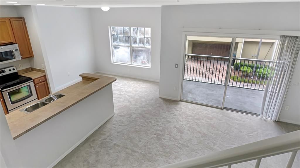 Living, Dining Room & Kitchen with Entrance to Screened Porch as seen from Stairs to Upstairs Bedrooms!