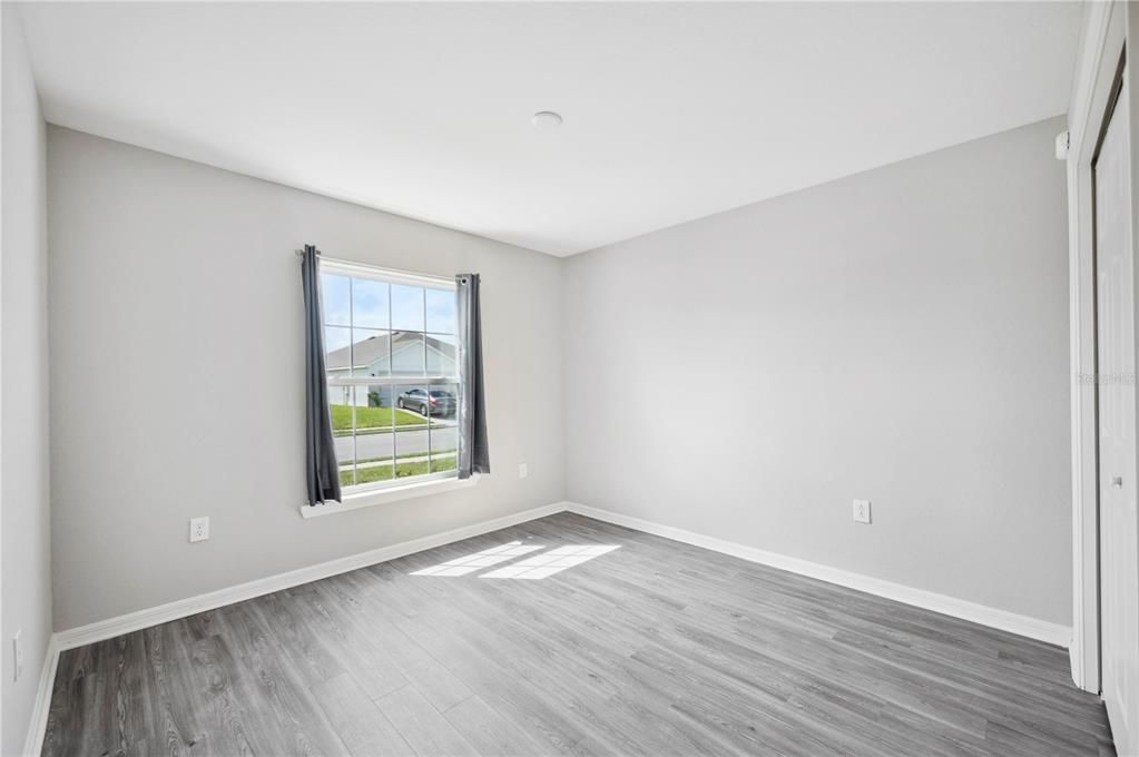 Bedroom 4 with window overlooking front yard.