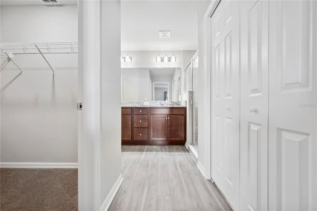 From Primary Bedroom looking through door to Master Bath. To left is walk in closet 1 of 2.