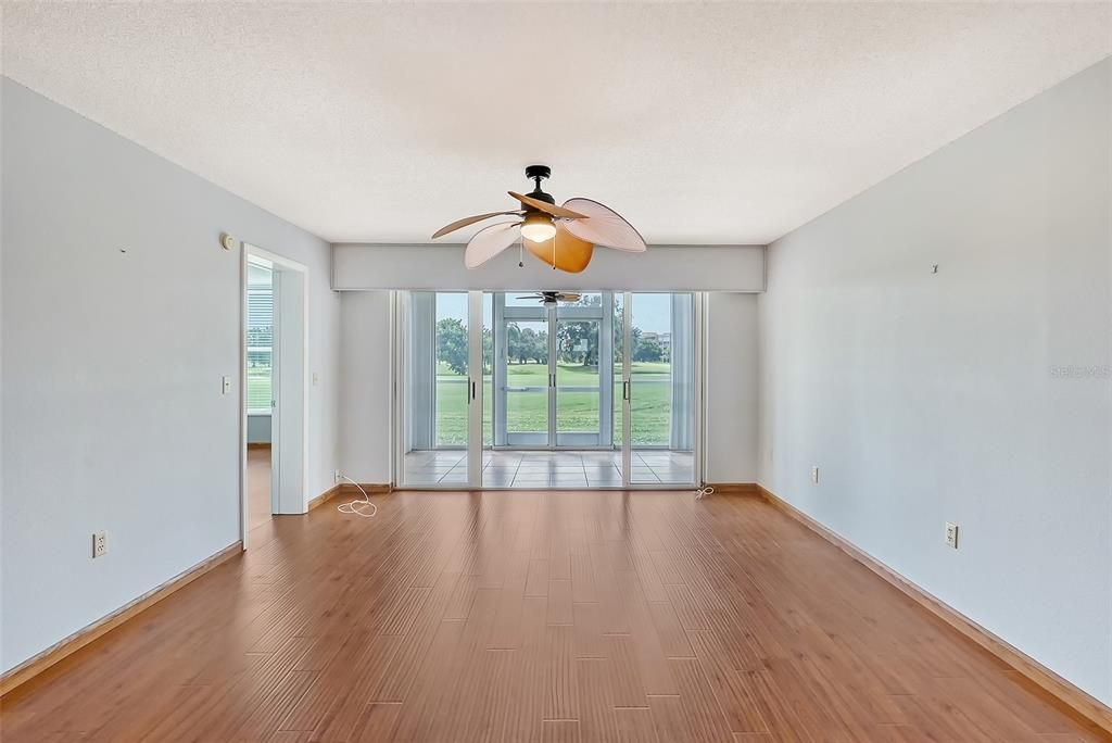 Living room and enclosed patio.  Door to primary bedroom