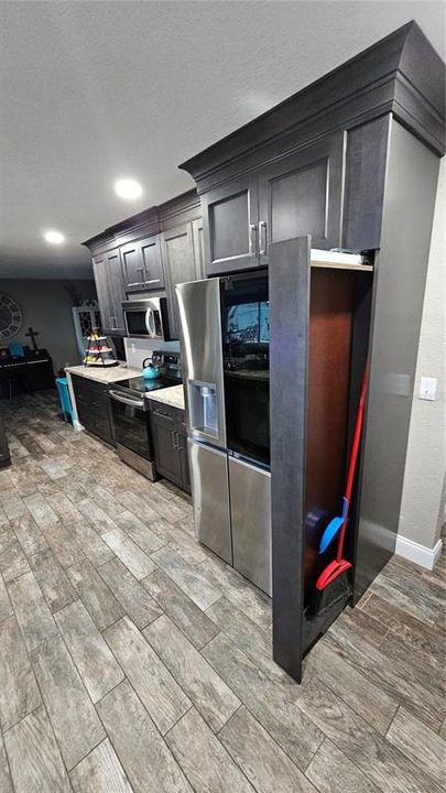 Kitchen with hidden broom closet