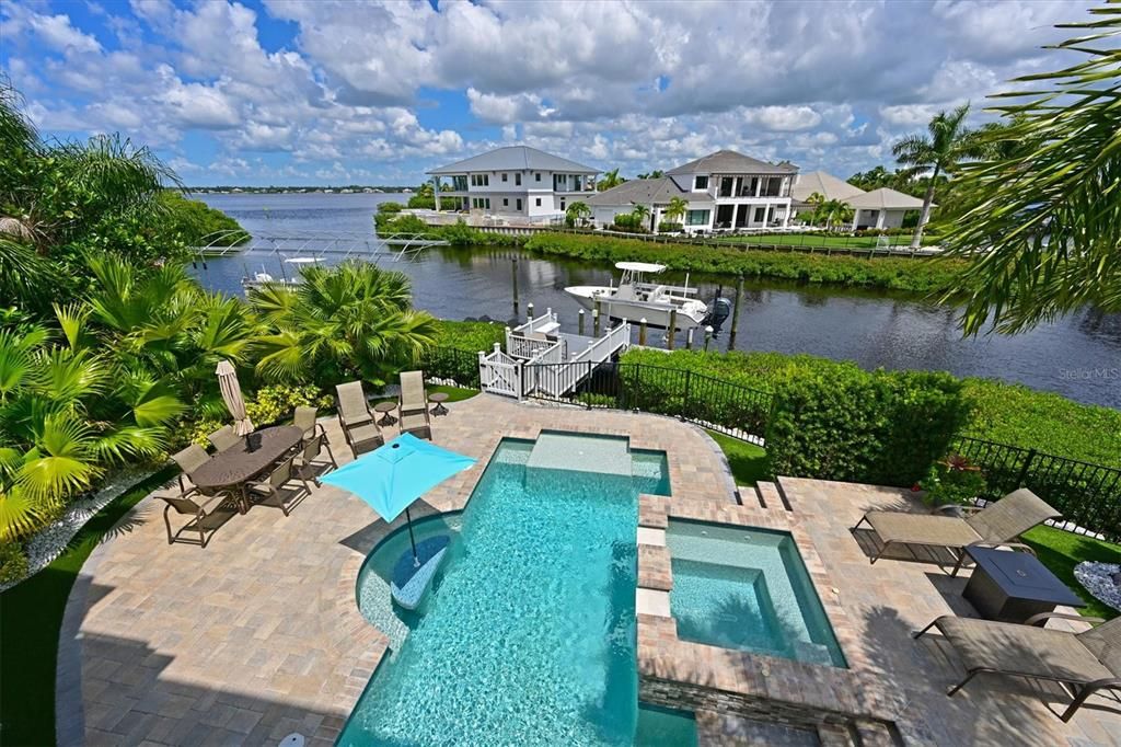 Saltwater pool and spa, floating dual private watercraft dock, boat dock with 14,000 lift, turf grass, fenced, and Manatee river views.