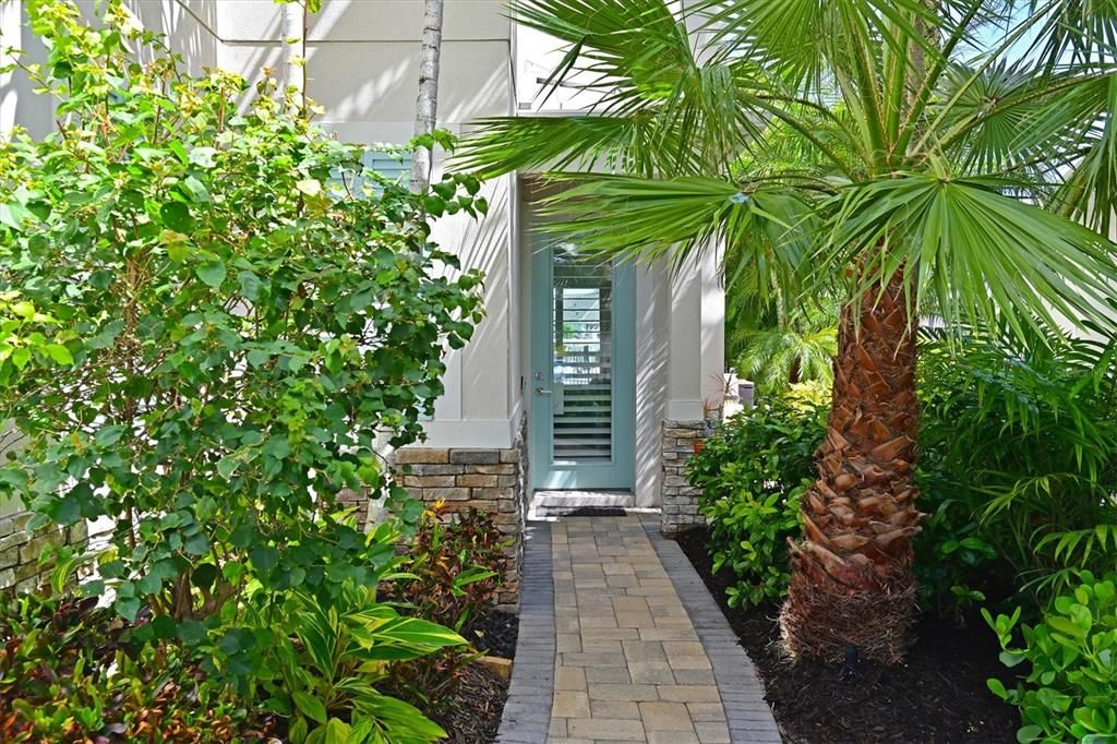 Entryway, the owner has brick paver pathway around the property on both sides. From the street they put in a stone path leading to the back yard.