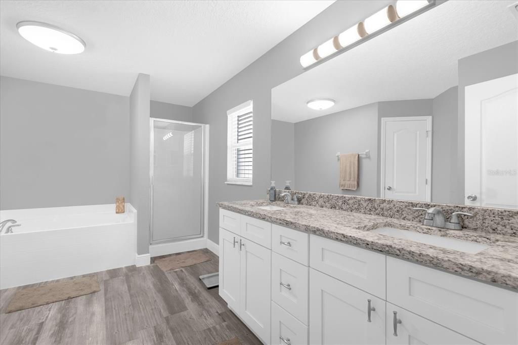 Owner's Spacious Ensuite Bathroom with dual sinks, large tub and walk-in shower