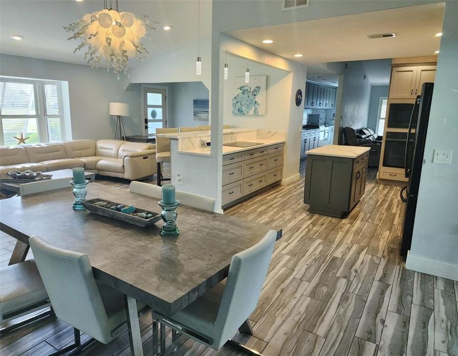 Looking over dining toward front door and kitchen.