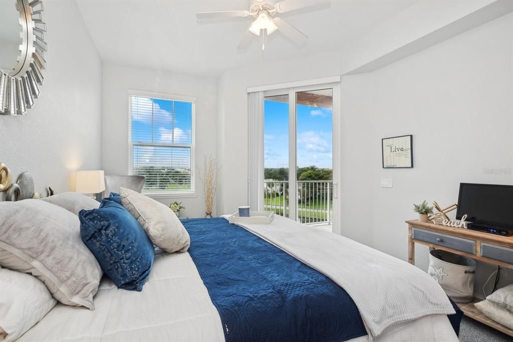 Primary bedroom with sliders to balcony