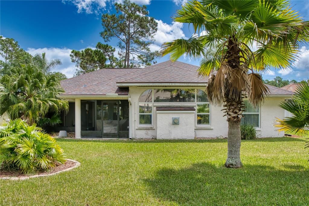 The back view of the home is equally stunning, showcasing its beautiful design and the seamless connection with the surrounding landscape.