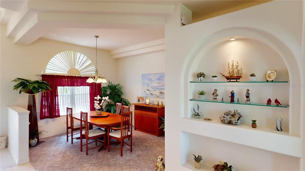 Separate dining area with large windows and an arched window, enhanced by a decorative step ceiling—creating a stylish and elegant space with direct access to the kitchen for easy serving and cleanup.