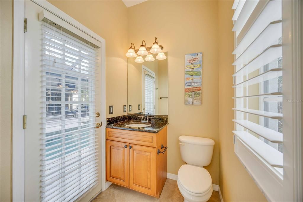 Fourth Half bathroom with direct access from inside and outdoor pool area, next to bonus, media room.