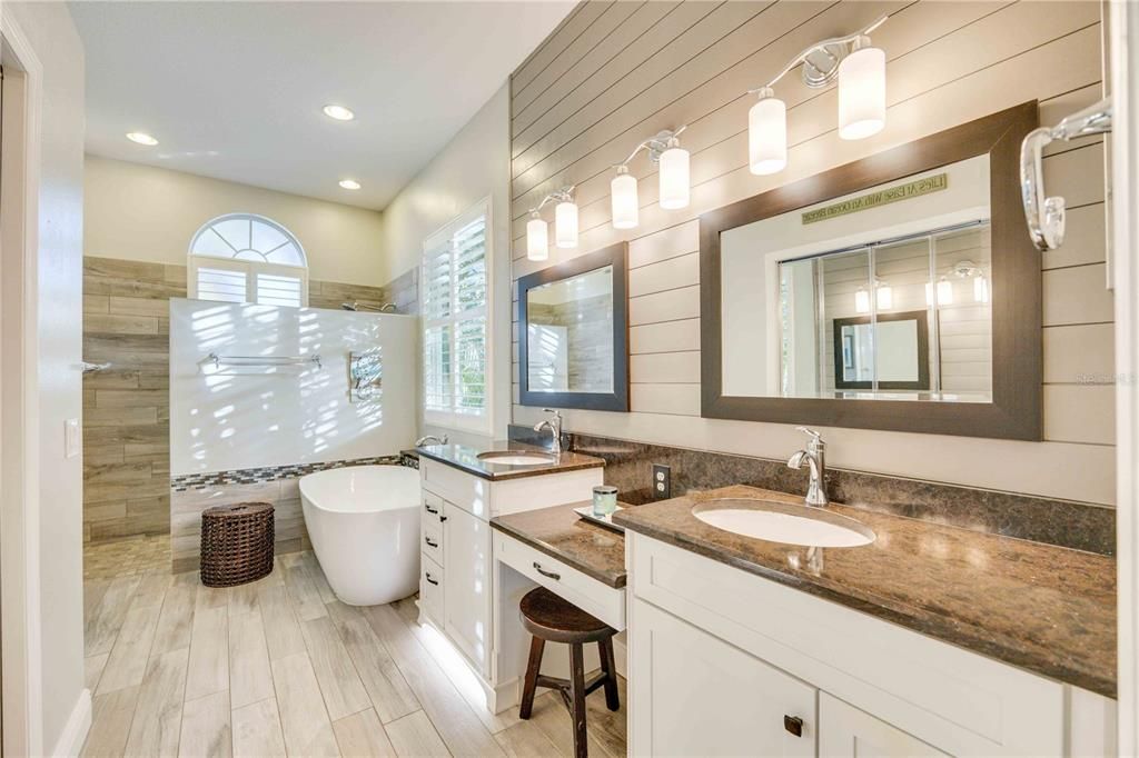 Ensuite bathroom equipped with double sink, make up vanity, large soaking tub and walk in shower, a spa retreat right at home