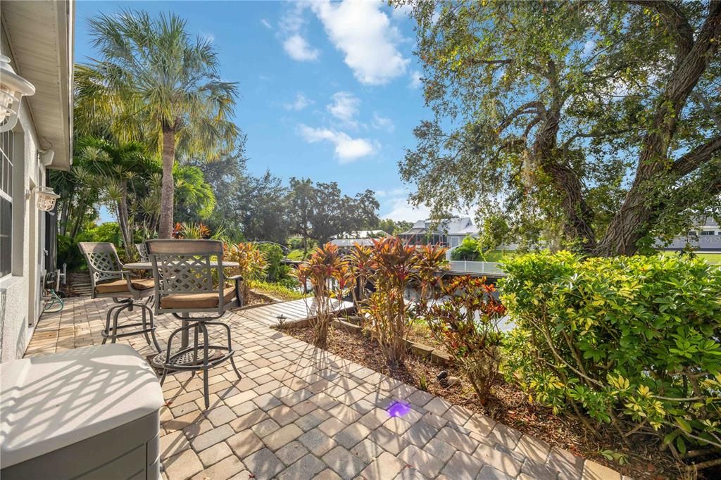 Outdoor uncovered lounge area leading to private dock, with outdoor hot and cold shower. Access to 4th bedroom, In-Law suite.