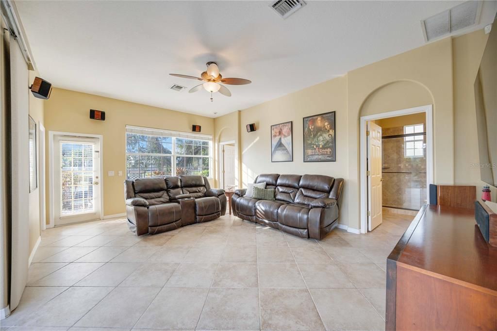 Large Living room with access to outdoor lanai area as well as walkway to boating dock. Living room has two bathrooms and is connected to fourth bedroom/office In-Law Suite with private entrance.