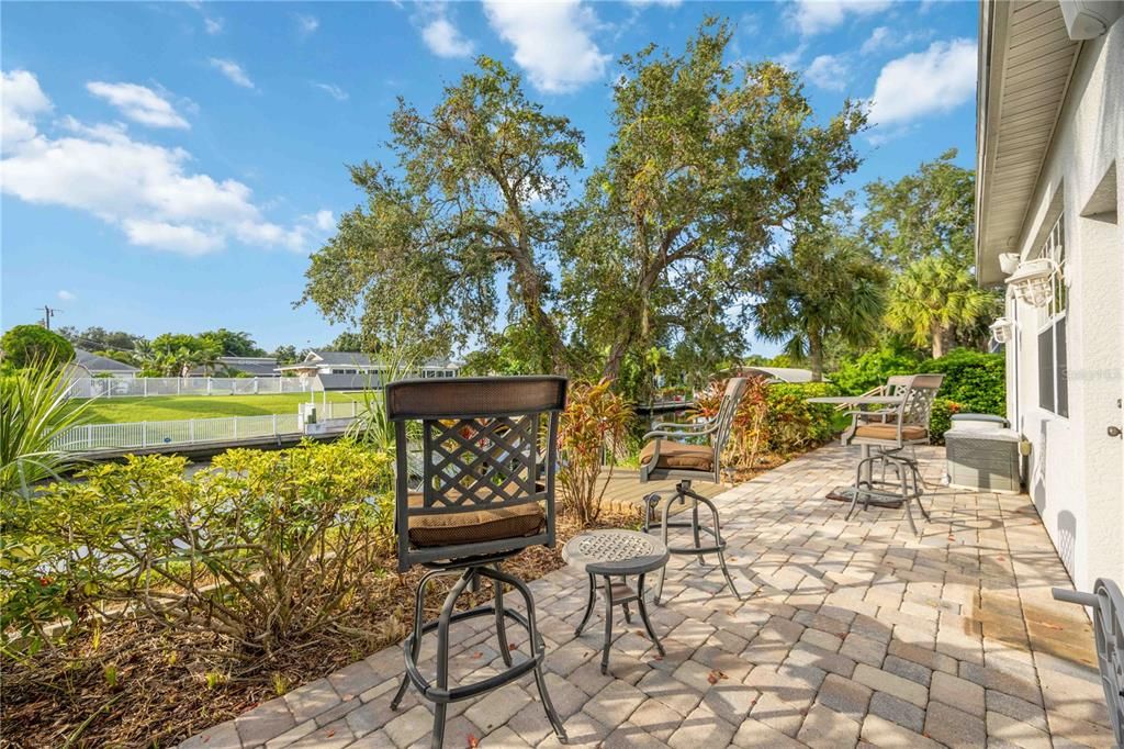 Outdoor uncovered lounge area leading to private dock, with outdoor hot and cold shower. Access to 4th bedroom, In-Law suite.