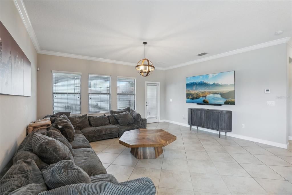 The kitchen is open to a casual dining space and the family room beyond where a wall of windows looks out onto the lanai and lets the natural light pour in.