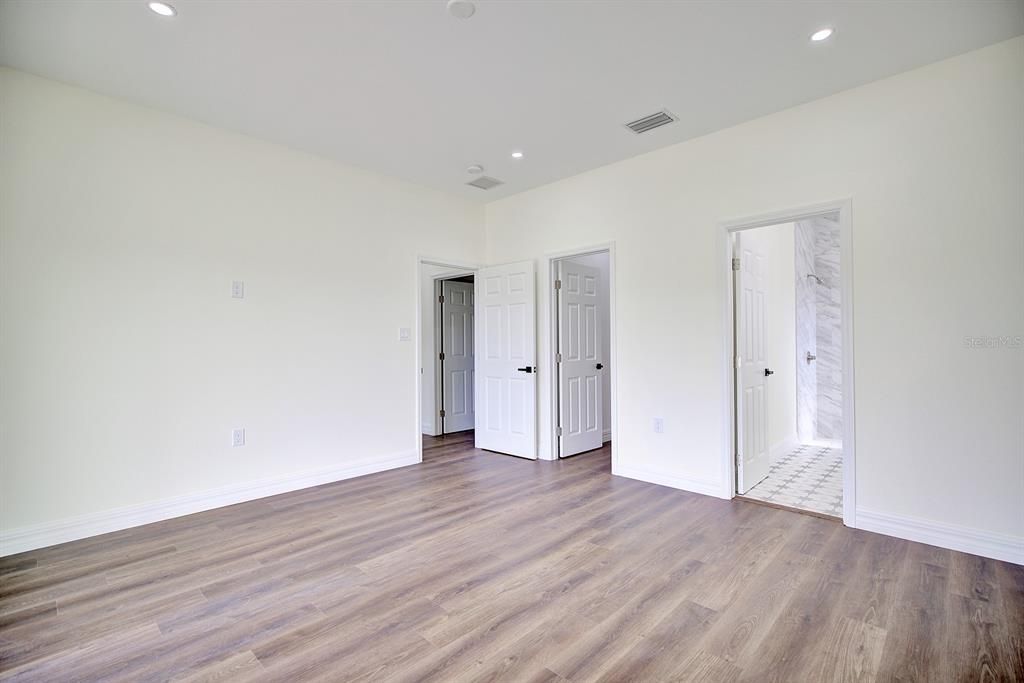 View of the primary bedroom from inside looking toward the entrance.