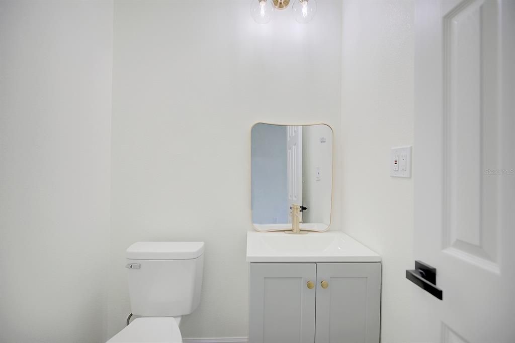 Powder room located in the entry hallway.