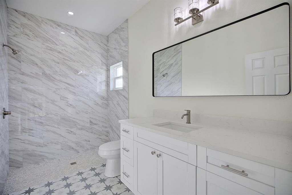 View into primary bathroom with shower stall.