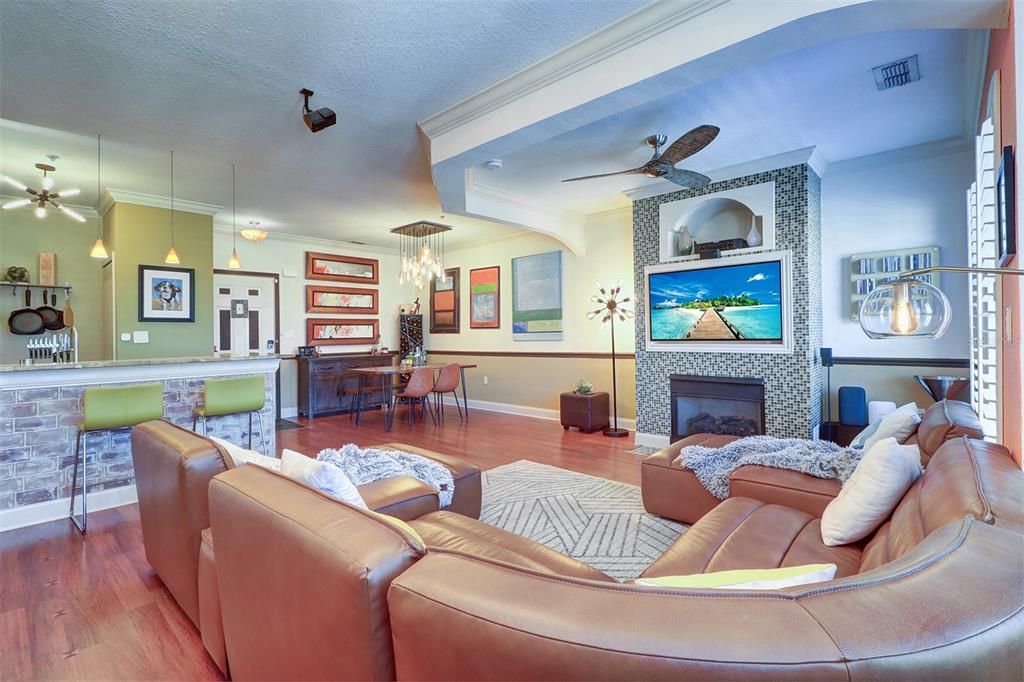 Spacious view from furthest living area  looking back toward the open entry, kitchen, dining and built-in entertainment center with gas fireplace