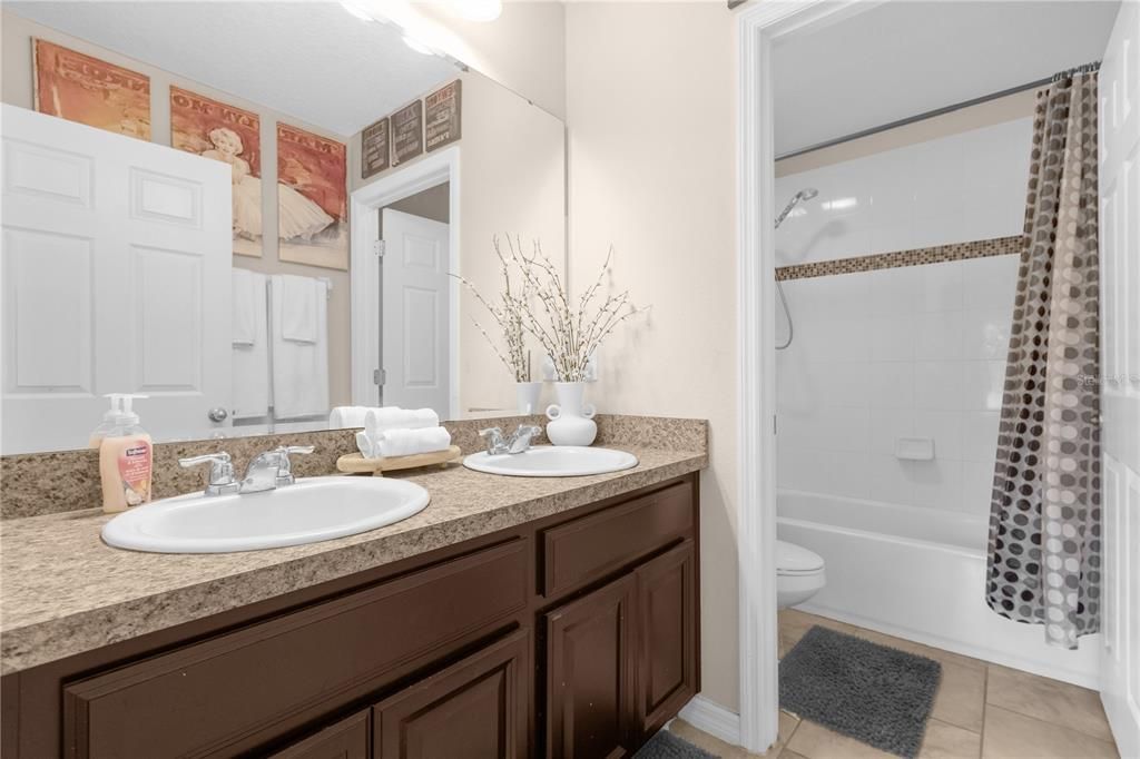 Bathroom 2 with twin vanity and tub with shower