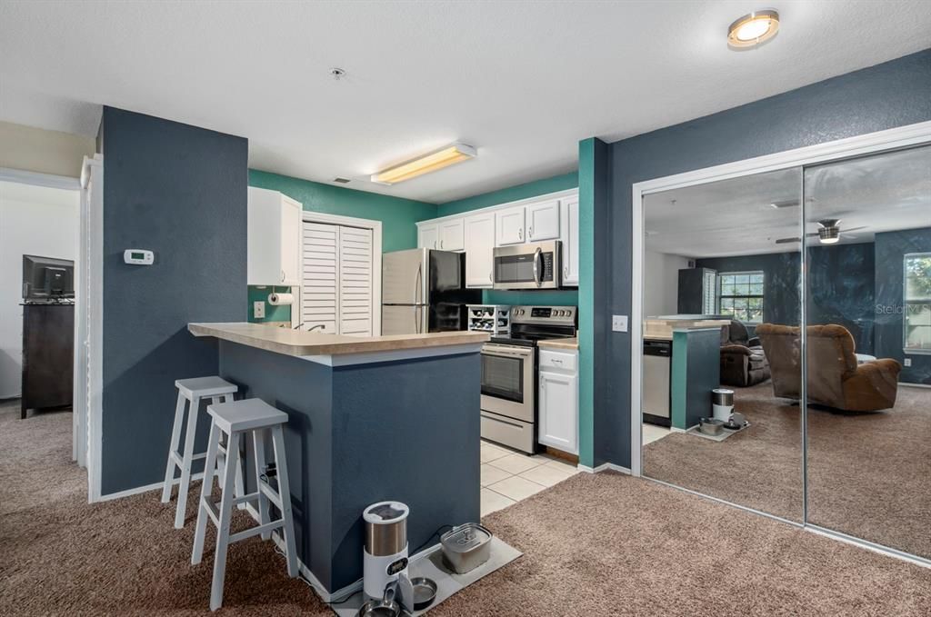 Dinning area with pantry.  Bar top for extra dining space.