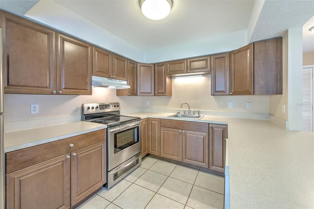 Kitchen with view from living room, dinette with view to the front door and flex space to the left