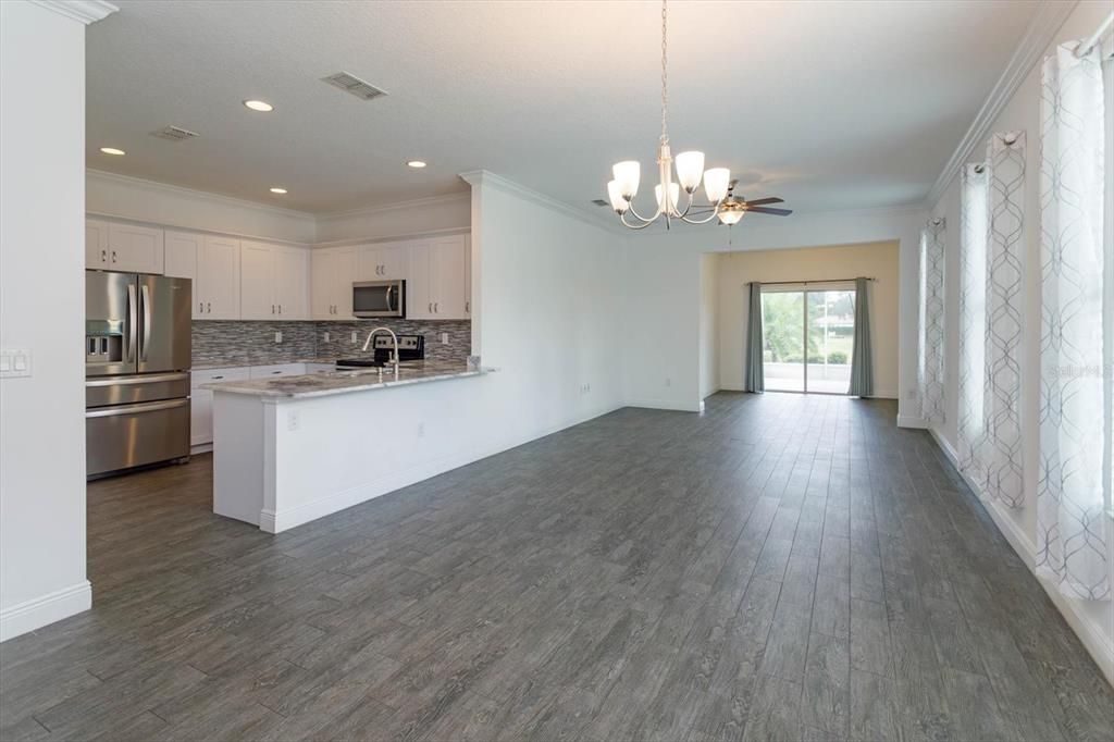 Looking from front entry into living areas and kitchen