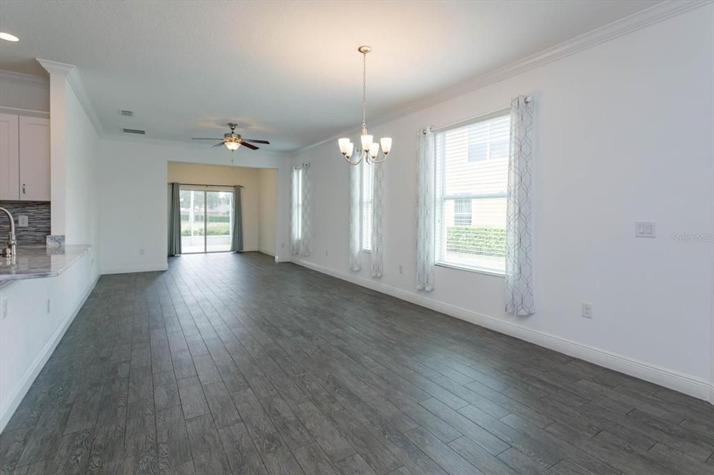 Dining/Living Room with porcelain tile flooring throughout and plenty of sunlight