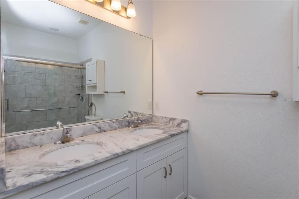 Master Bathroom with dual sinks and granite countertops