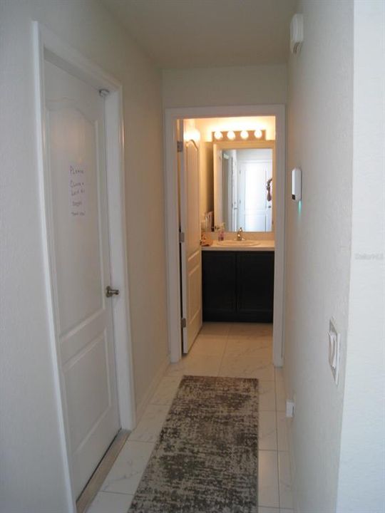 Hallway to garage and guest bathroom.