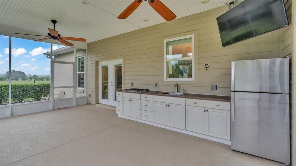 screened porch with outdoor kitchen