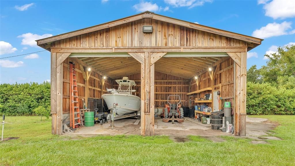 detached garage with extra large roll up doors with room for boats, RV's, and more