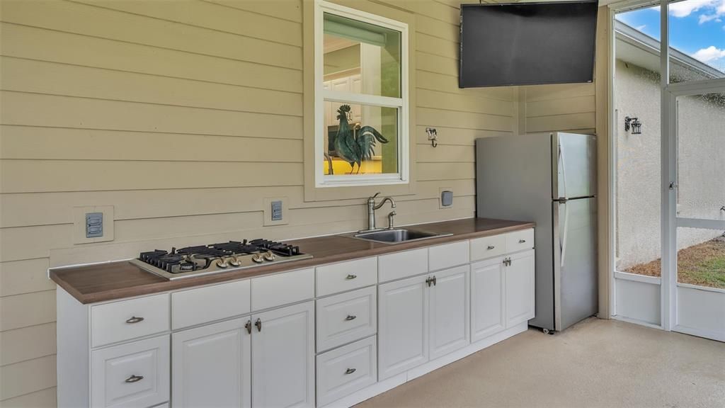 screened porch with outdoor kitchen