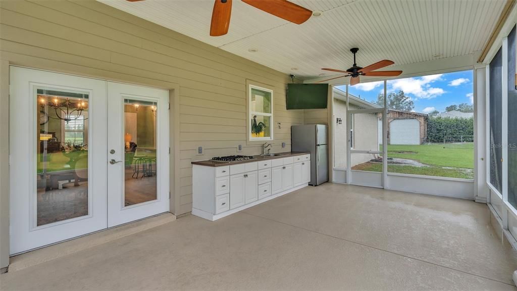 screened porch with outdoor kitchen