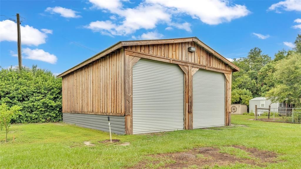 detached garage with extra large roll up doors with room for boats, RV's, and more