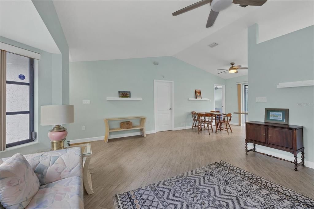 living room view showing dining area, closed door mid point is laundry room