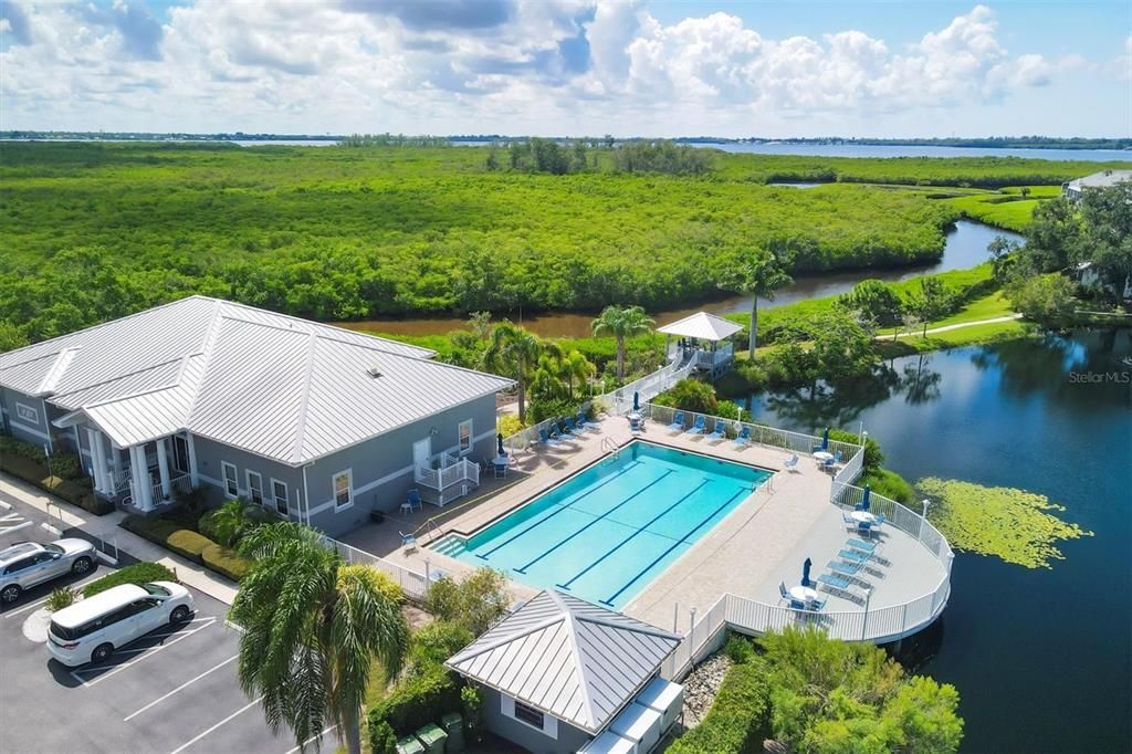 Perico Bay Club Community junior Olympic lap pool and club house holds the community Fitness Center, multiple meeting areas with full kitchen for food preparation, both screened-in and open-air seating areas and a community library