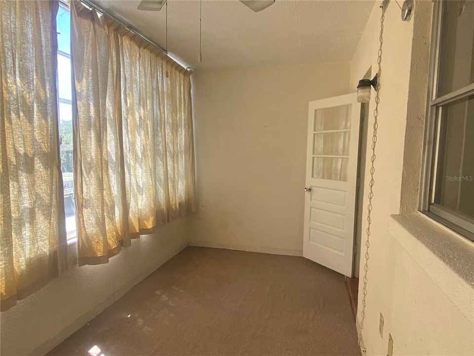 Storage closet behind you, view of Florida room back towards the door leading to the kitchen. NOTE* THERE IS A SMALL STEP DOWN FROM KITCHEN TO FLORIDA ROOM**