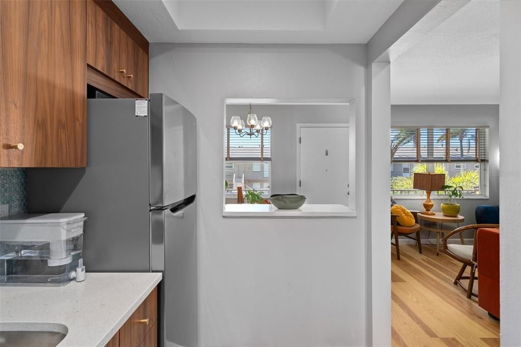 The kitchen features a full size, stainless steel refrigerator/freezer.