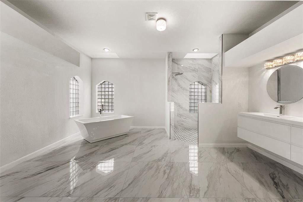 Fully remodeled Master Bathroom featuring shower with separate soaking tub