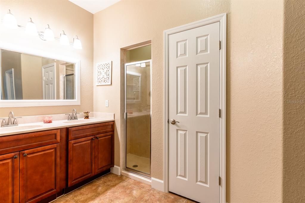 Master bathroom with his and her sinks, large walk in shower and his and her walk in closests