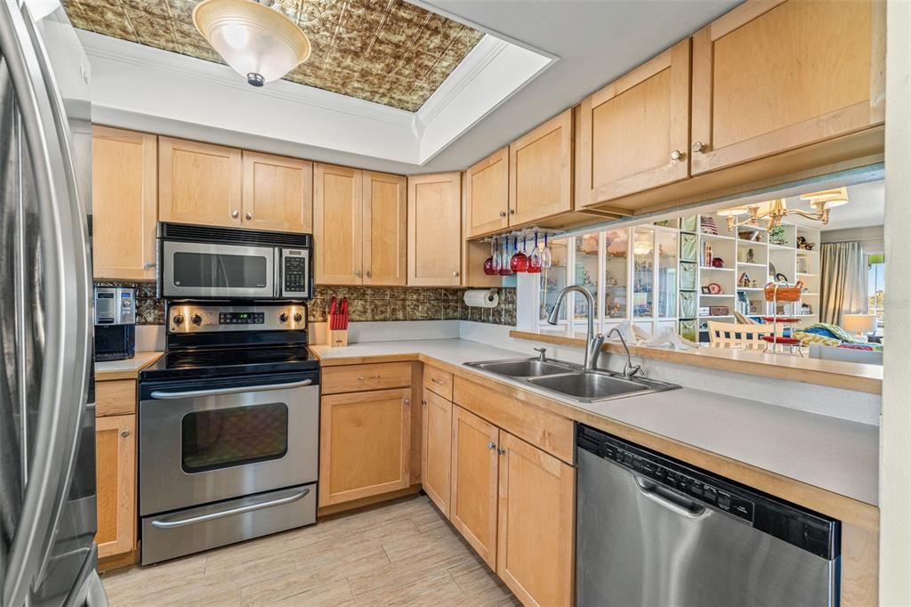 Kitchen with breakfast bar and pass-through to dining room.