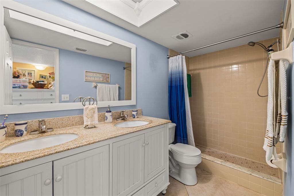 Dual sink vanity, walk-in shower, comfort height toilet, updated lighting and vanity mirror