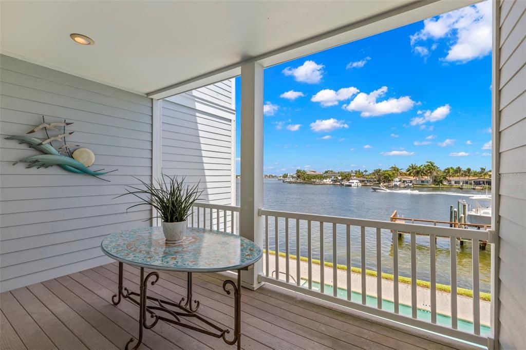 Your private oasis awaits! This covered balcony is the perfect spot to enjoy morning coffee or evening cocktails while taking in the stunning water views and watching boats cruise by.