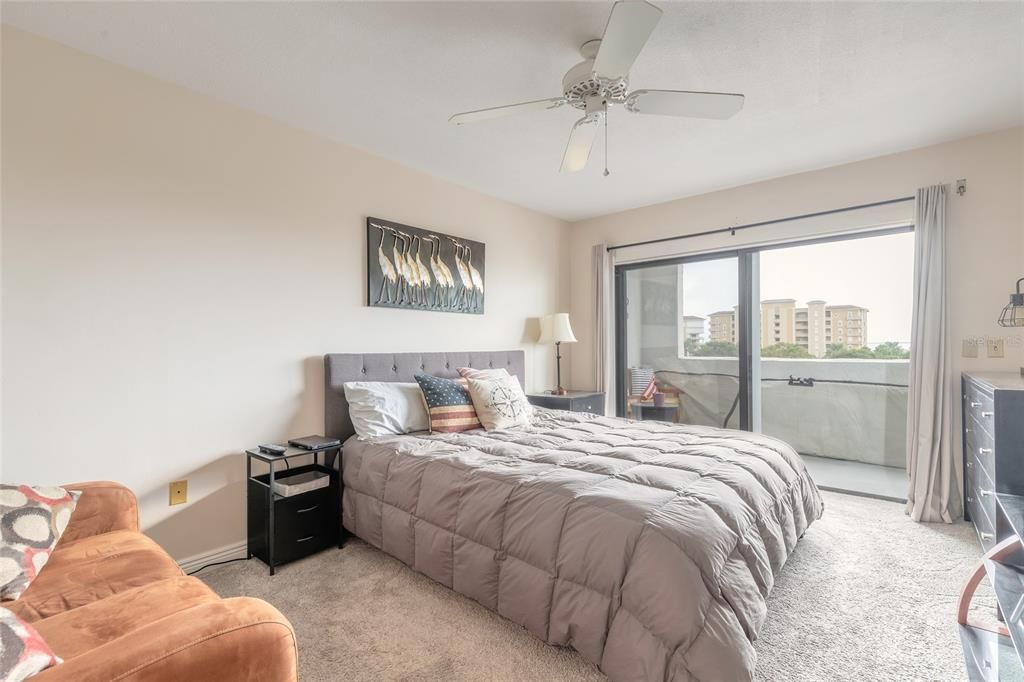 Primary Bedroom with a Balcony and View