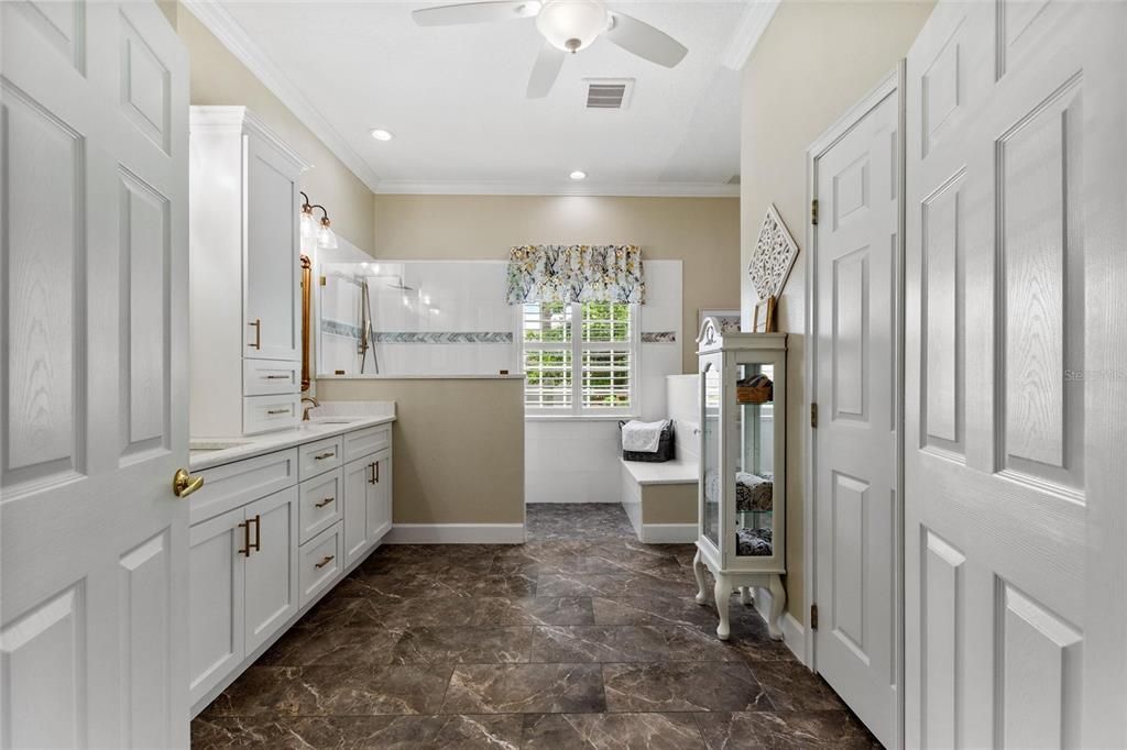 Primary bathroom has linen and walk-in closets