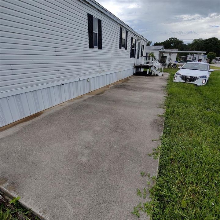 Concrete patio stretches all the way across the front and back of the home.