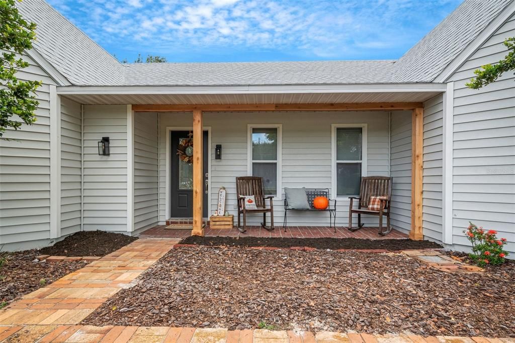 This charming home features an adorable front porch , perfect for sitting.